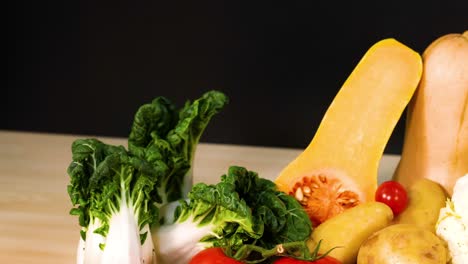 assorted vegetables arranged on a black background