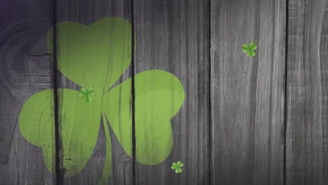 Animation-of-green-clovers-floating-with-clover-leaf-on-background-for-St.-Patricks-day