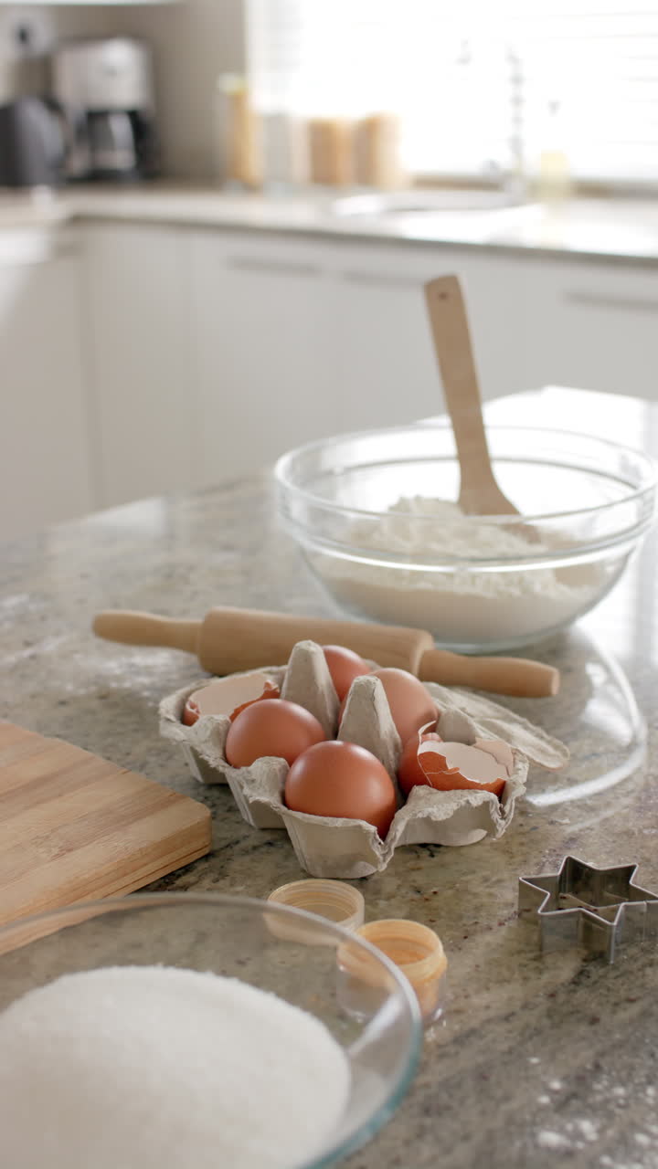 Vertical video baking ingredients on countertop in kitchen in slow motion