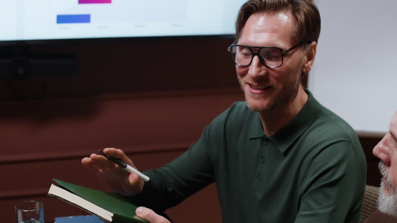 People taking notes and discussing at a business meeting