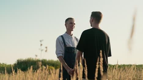 men holding hands outdoors