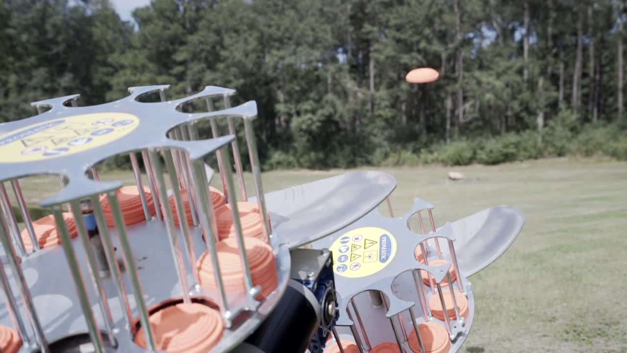 Skeet shooter launching clay targets to be shot