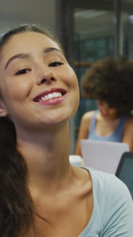 portrait of caucasian businesswoman smiling over diverse business colleagues talking