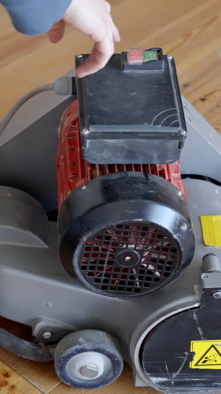 Starting a powerful sanding machine, close up vertical view