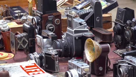 vendors on the streets of havana cuba sell old cameras radios and propaganda books and posters 1