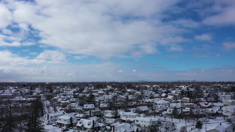 an aerial view over a suburban neighborhood in the morning, after a snowstorm the night before