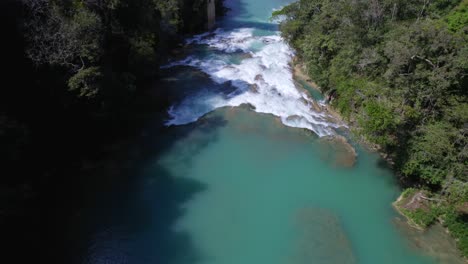 Volando-Hacia-Atrás-Desde-Un-Puente-Que-Cruza-Un-Río-De-Agua-Turquesa-En-Medio-De-La-Selva-De-Chiapas,-México