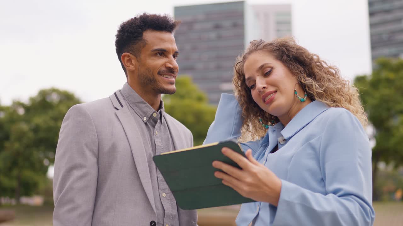 Business professionals using a tablet in an urban environment