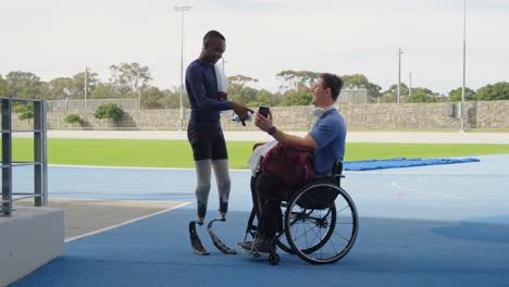 Two-disabled-athletics-discussing-over-mobile-phone-4k