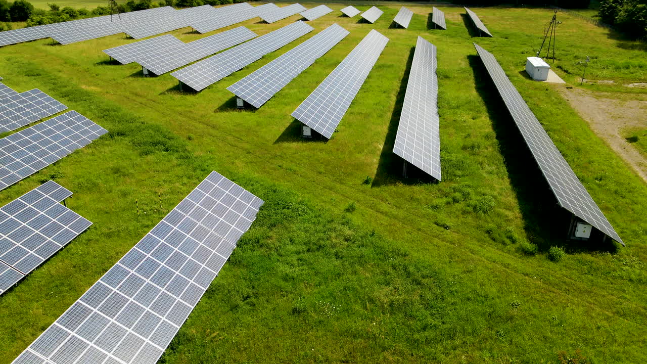 зеленый луг с солнечными батареями - взлет с воздуха