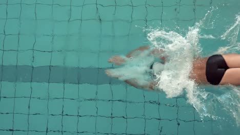 fit man diving into the pool