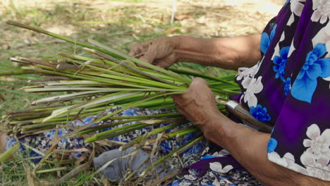 skilled artisan cuts and dries natural materials in the sun, an essential step in the traditional process of crafting comfortable mattresses in quang nam,