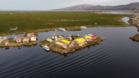 a village on a floating island on lake titicaca, orbit drone shot