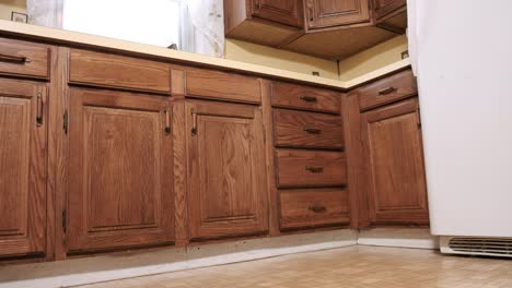 low angle move in and out wide shot of old yellow kitchen corner