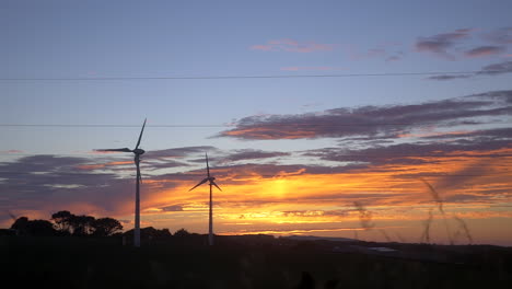 Onshore-Windkraftanlagen-Vor-Dem-Farbenfrohen-Sonnenuntergangshimmel-Cornwalls