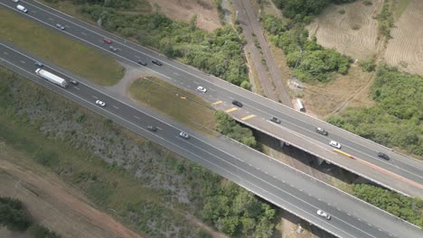 Aerial-shot-of-busy-two-ways-traffic-at-the-suburban-of-Sydney-with-cloud-shadow-slowly-covering-the-sky-and-sunlight