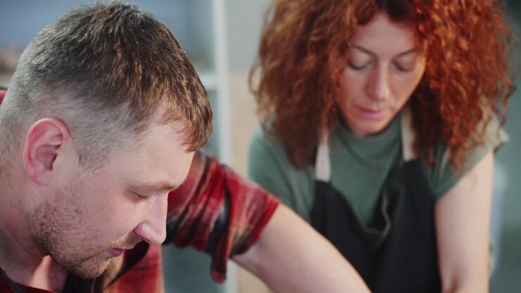 Couple working together on pottery