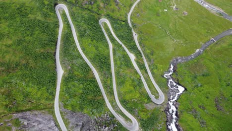 special winding roads at halsabakkane close to sendefossen in vikafjellet mountain crossing norway - unique birdseye perspective looking down at curvy road climbing up steep mountain