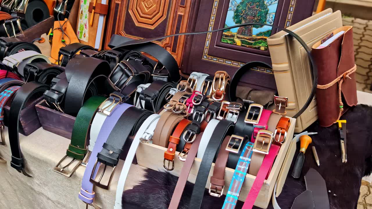 Collection of leather belts in various colors and styles, genuine calf leather products shop
