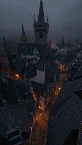 dark foggy medieval european town at night