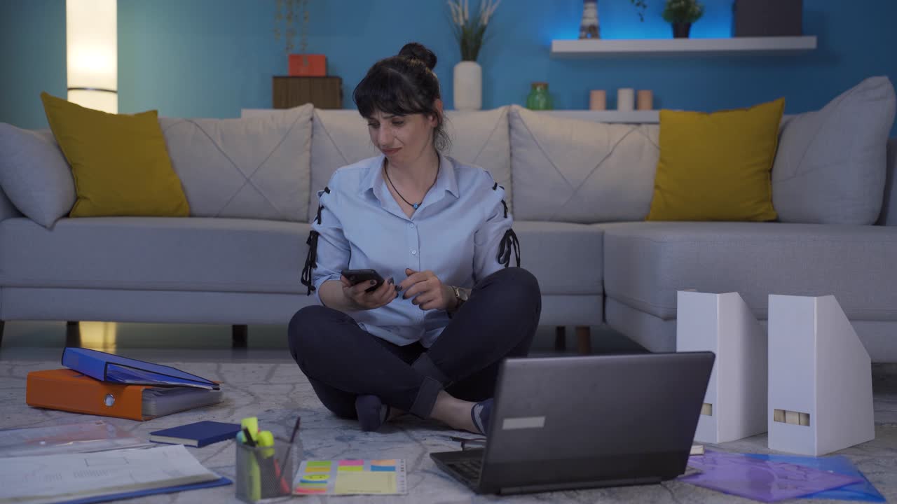 Home office worker woman has phone charging problem, battery runs out.