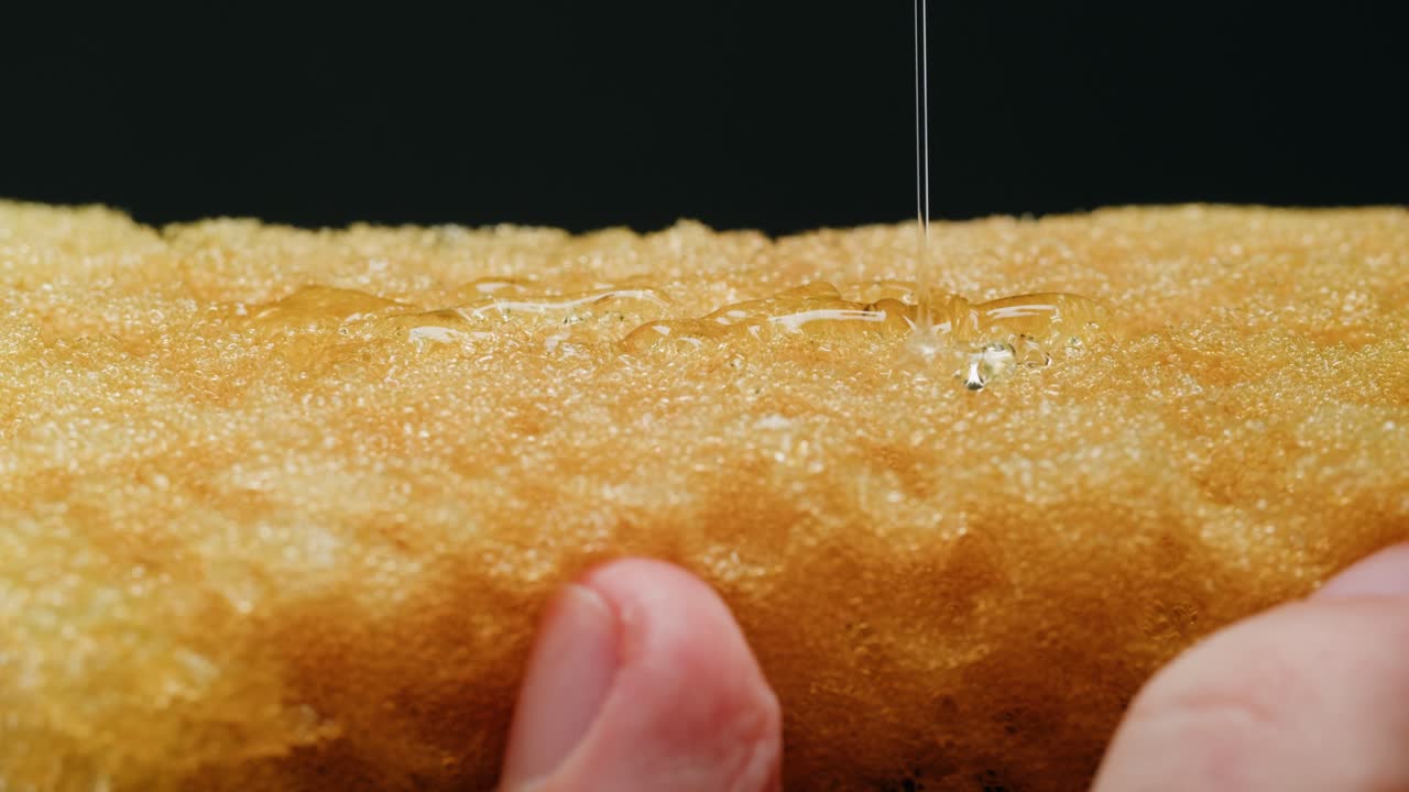 Honey dripping on a sponge