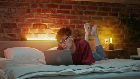 hombre trabajando en la computadora portátil en la cama