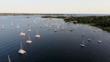 Aerial-view-of-many-sailboats-docked-in-bay-in-Jamestown-Rhode-Island-during-golden-hour