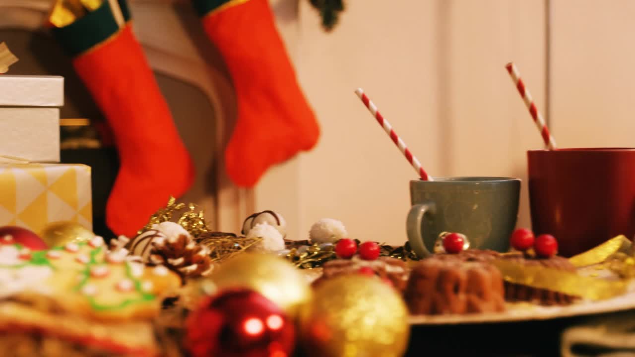 Red sleigh reindeer silhouette entering left traveling over mugs exiting right adding festive flair