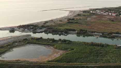 aerial view of fishing huts with typical italian fishing machine, called ""trabucco"",lido di dante, fiumi uniti ravenna near comacchio valley
