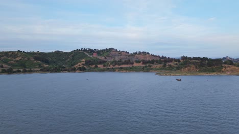 aerial view of point molate beach reveals peaceful waves meeting a quiet shoreline tucked beneath gentle hills.