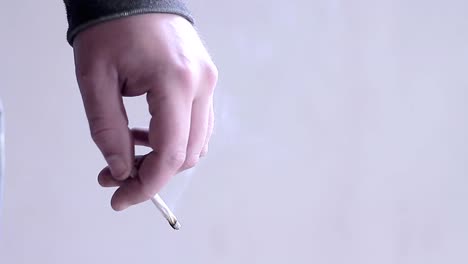 legalising cannabis smoking cigarettes with hand stock footage