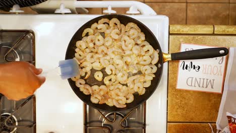 stirring prawns as the simmer in a skillet