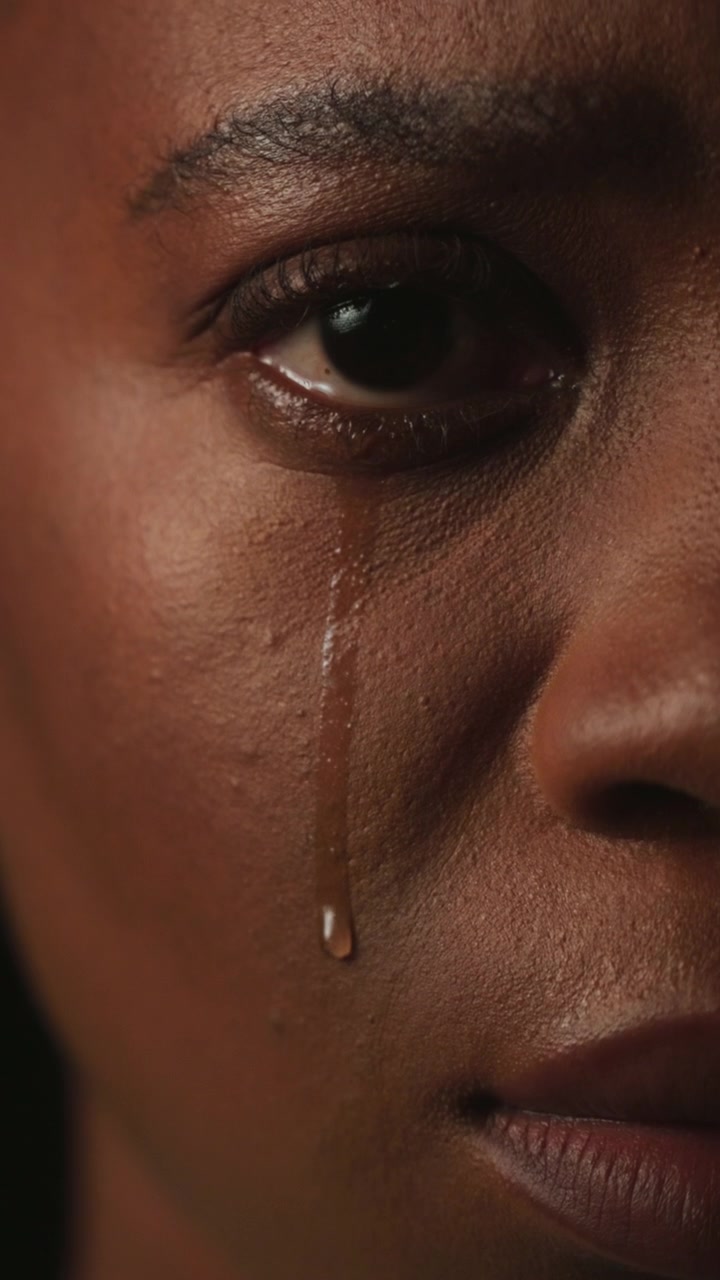 Close-up of a Woman Crying with Tears Streaming Down Her Face