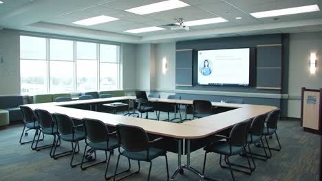 bright and modern conference room set up for productive meetings, featuring a large table surrounded by chairs and advanced presentation technology