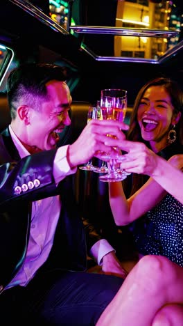 affluent couple laughing, toasting champagne glasses while sharing intimate moments inside luxurious limousine during elegant nighttime celebration