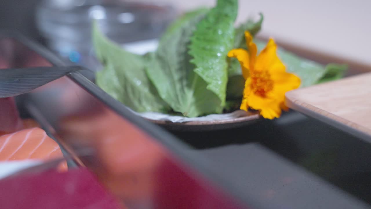 A roaming shot showcasing various sushi ingredients and raw fish, highlighting their textures, colors, and freshness, perfect for sushi preparation or other seafood dishes.