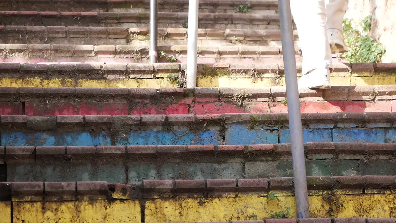 Person walking up colorful stairs