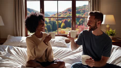 couple enjoying coffee in bed with a mountain view