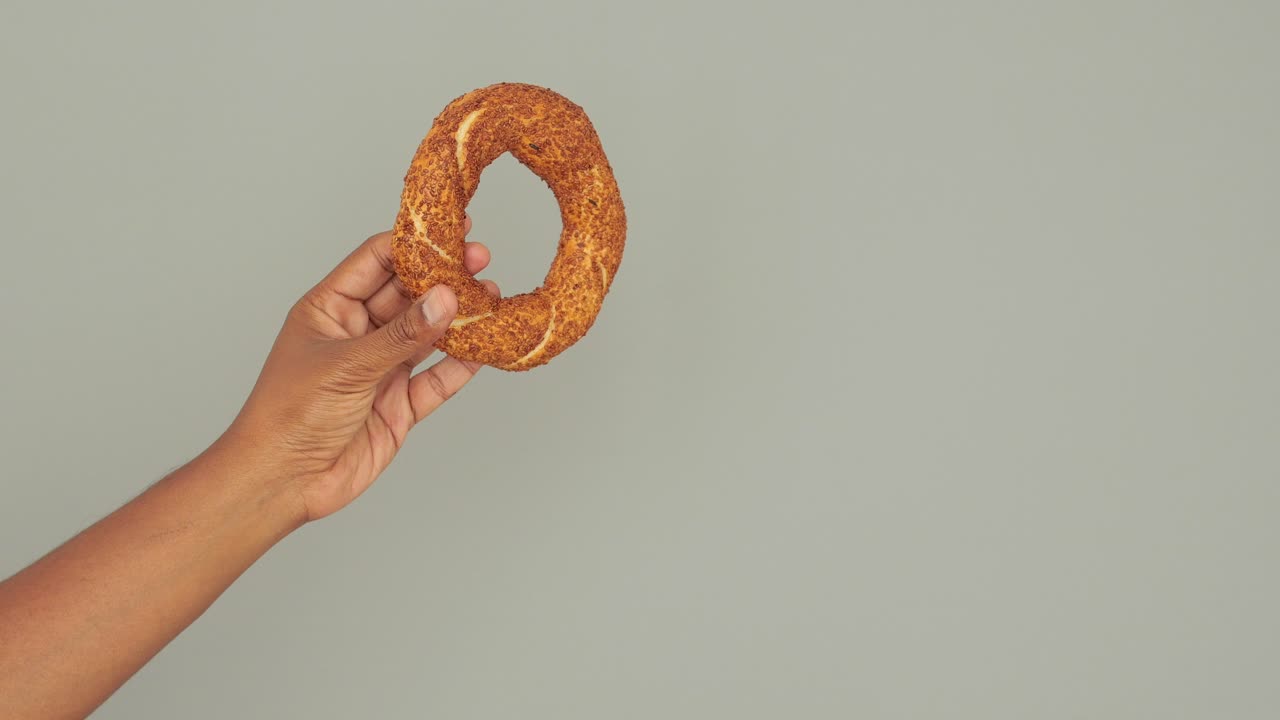 Hand holding a simit