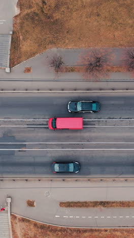 aerial view of bridge traffic. tracking the car that goes to the bridge. vertical video