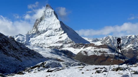 camera tripod lake riffelsee zermatt switzerland glacier gornergrat railway train stop autumn october clear afternoon blue sky the matterhorn peak first snow landscape scenery swiss alps slider right