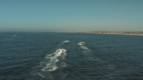 Beautiful-aerial-drone-of-California-coastal-beach-with-Jetski---Graded