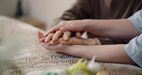 woman comforting wrinkled old hand 4