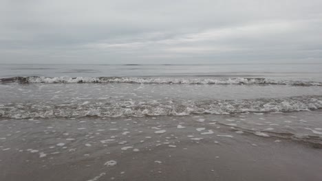 Pedestal-down-shot-of-infinite,-wide-sea-on-cloudy-day