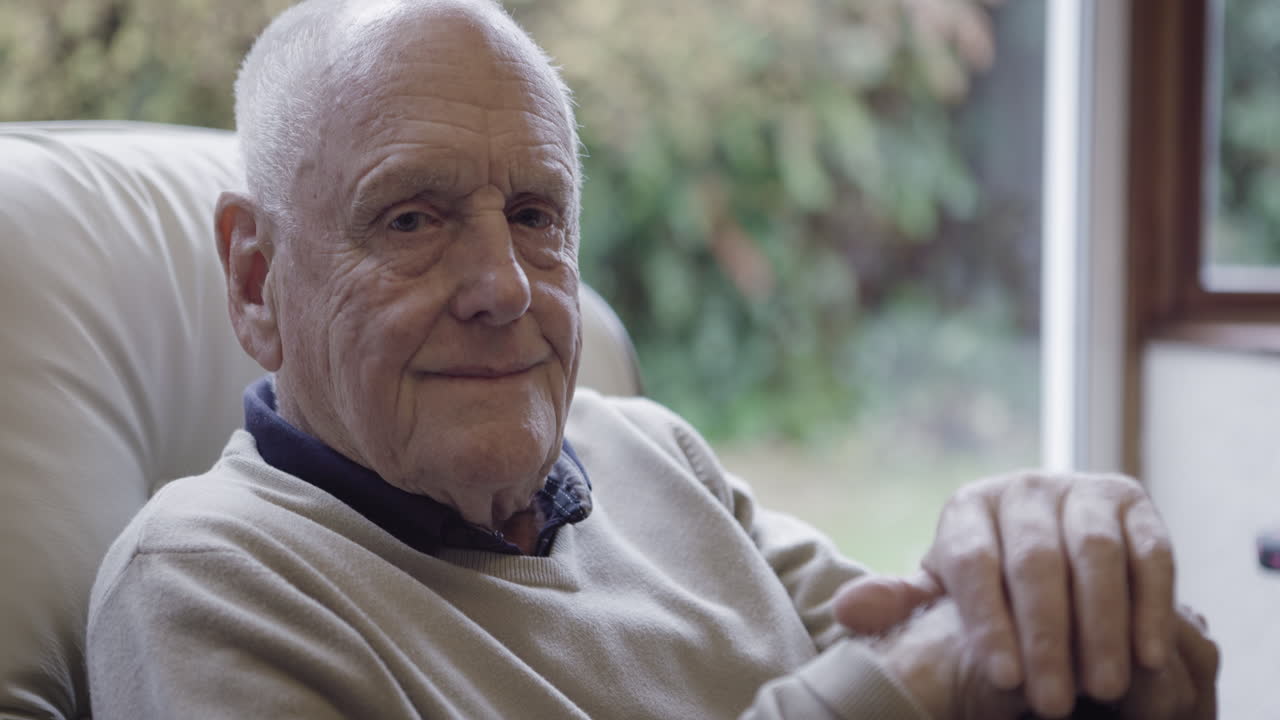 Elderly man smiling indoors