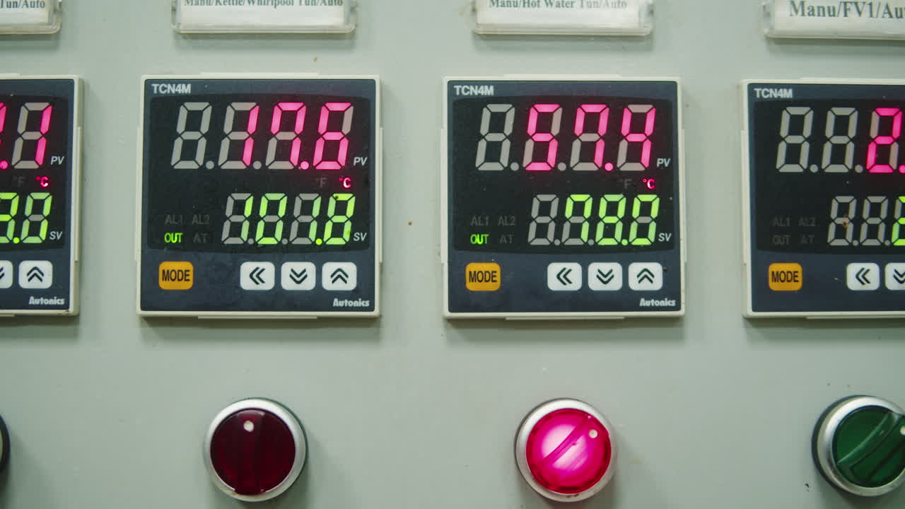 Craft beer production factory, brewery manufacture. Putting barley malt grains in conveyor close-up. Brewing, cooking alcohol in metal vats bottles