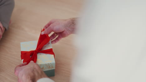 close up of hands wrapping a christmas present