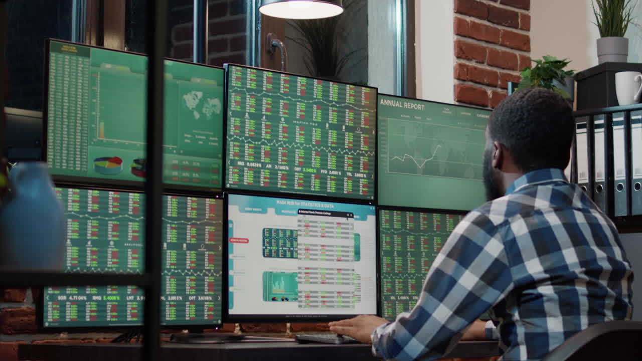 Male financial analyst looking at real time stocks exchange