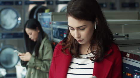 Young-Pretty-And-Stylish-Girl-Sitting-In-Laundry-Service-Room